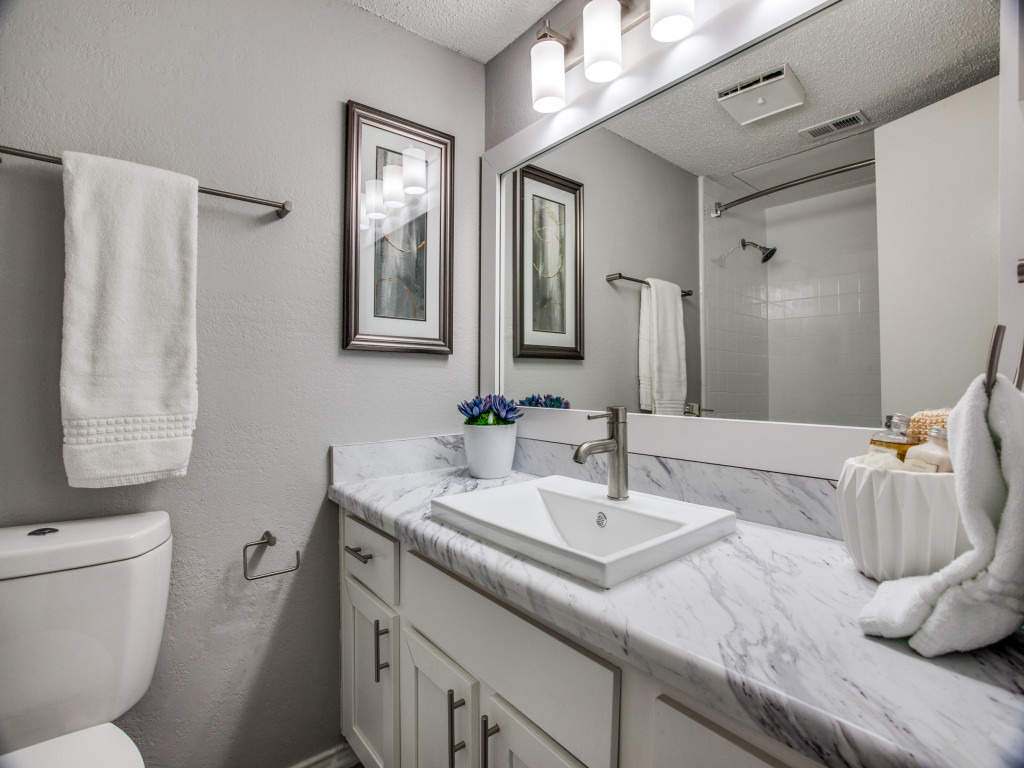 model bathroom with vinyl wood-look flooring and brushed nickel hardware